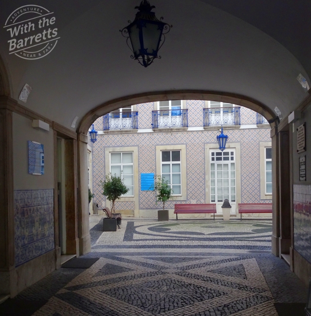 Looking through to tile on the walls of courtyard